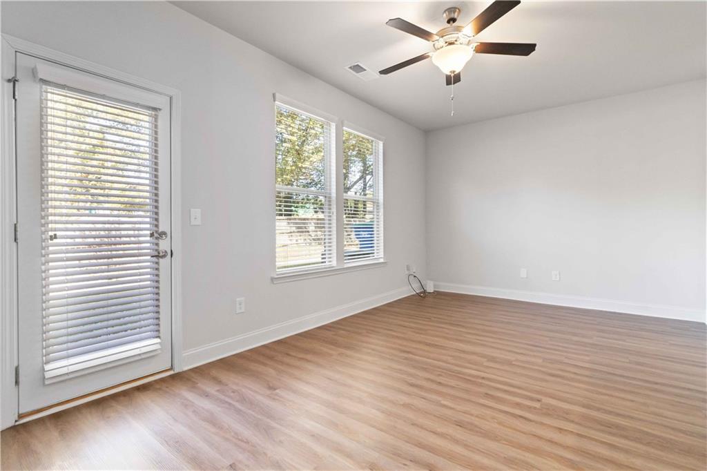 3437 Sumersbe Court Atlanta, GA 30349 - Photo 8 of 25 a view of an empty room with wooden floor and a window