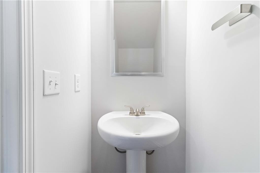 3437 Sumersbe Court Atlanta, GA 30349 - Photo 10 of 25 a bathroom with a sink and a mirror