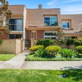 a view of a house with a yard and potted plants