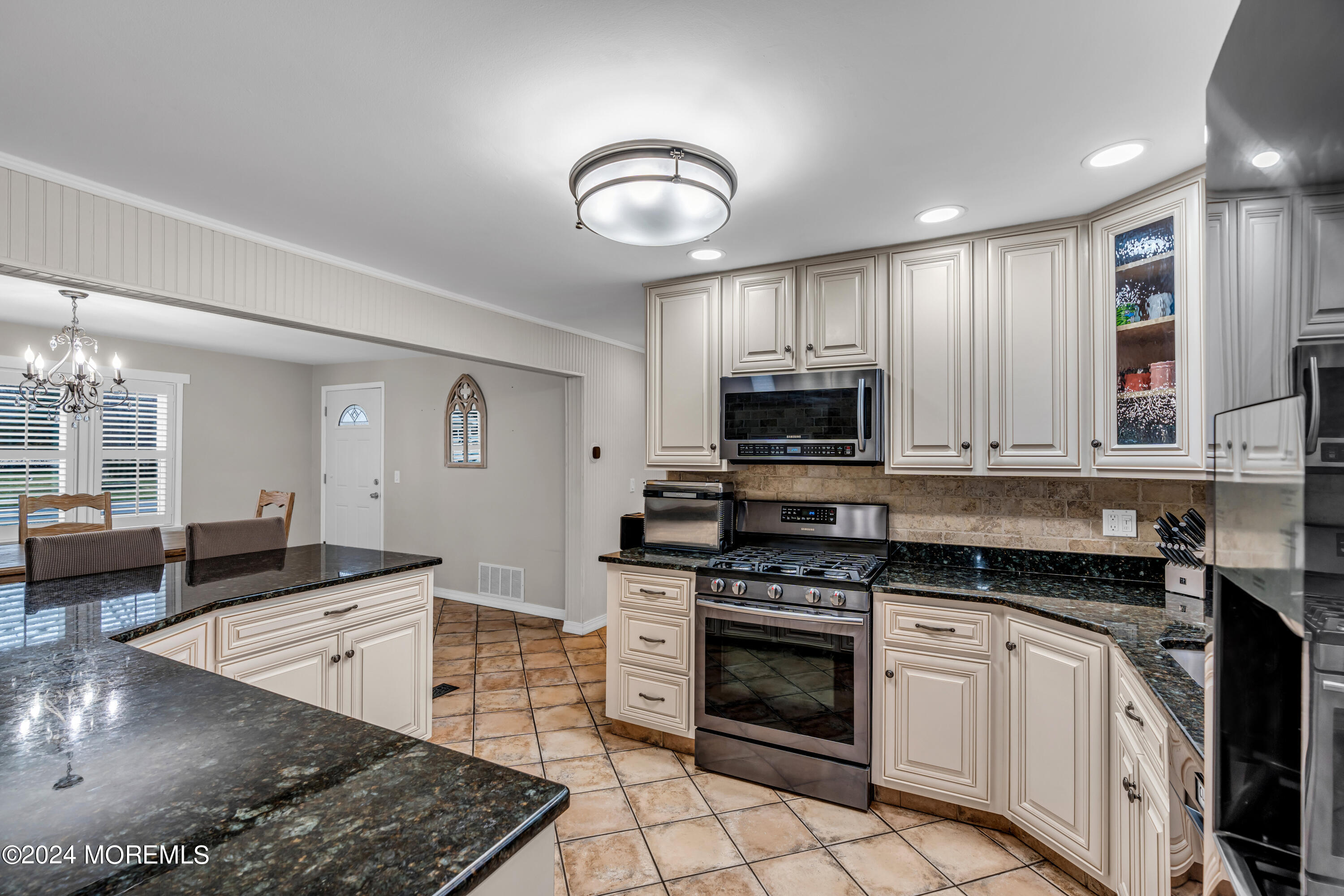 2 Maple Avenue Freehold, NJ 07728 - Photo 12 of 41 a kitchen with stainless steel appliances granite countertop a stove top oven a sink a counter space and cabinets
