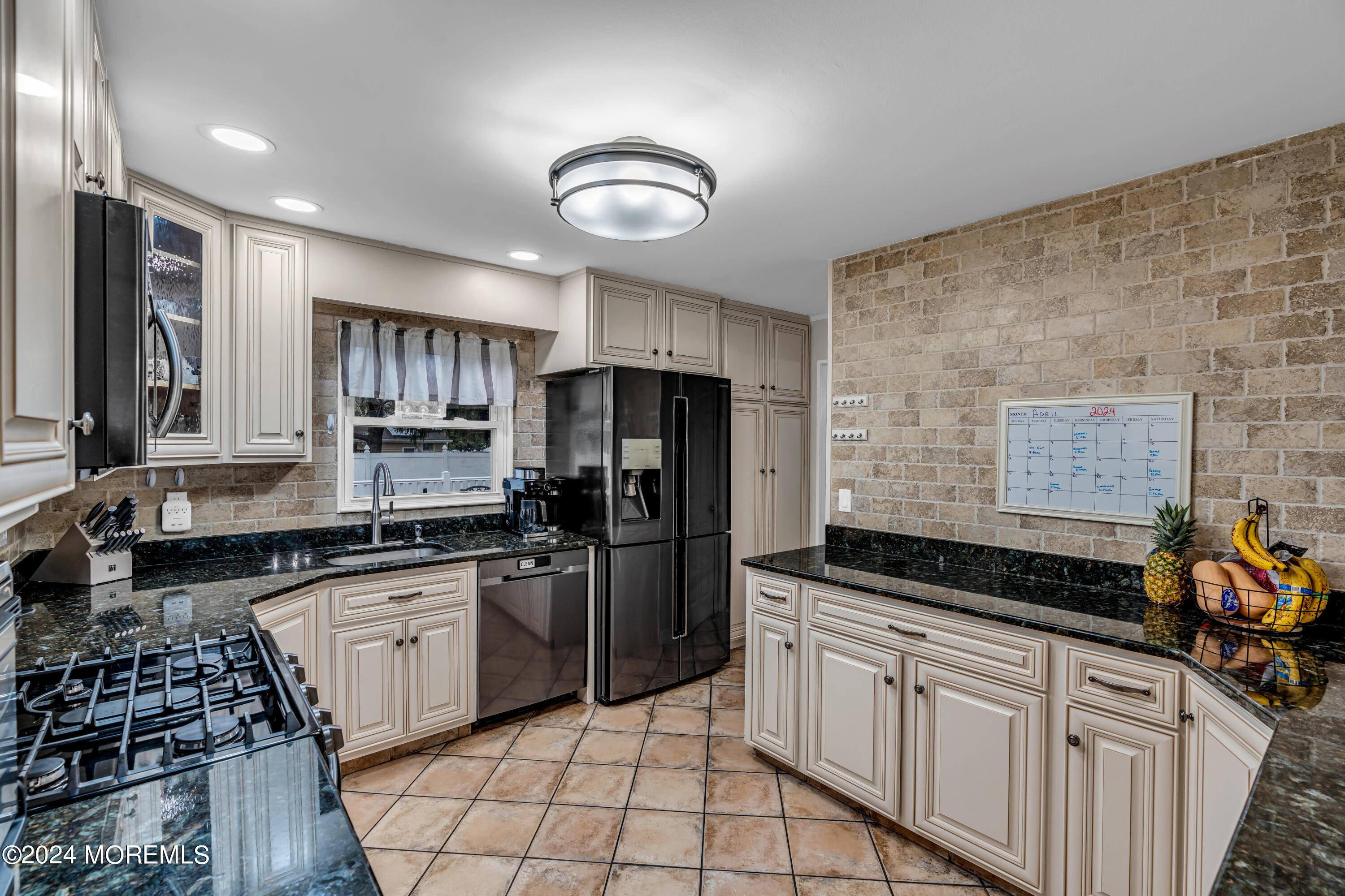 2 Maple Avenue Freehold, NJ 07728 - Photo 15 of 41 a kitchen with granite countertop a stove a sink a refrigerator and cabinets