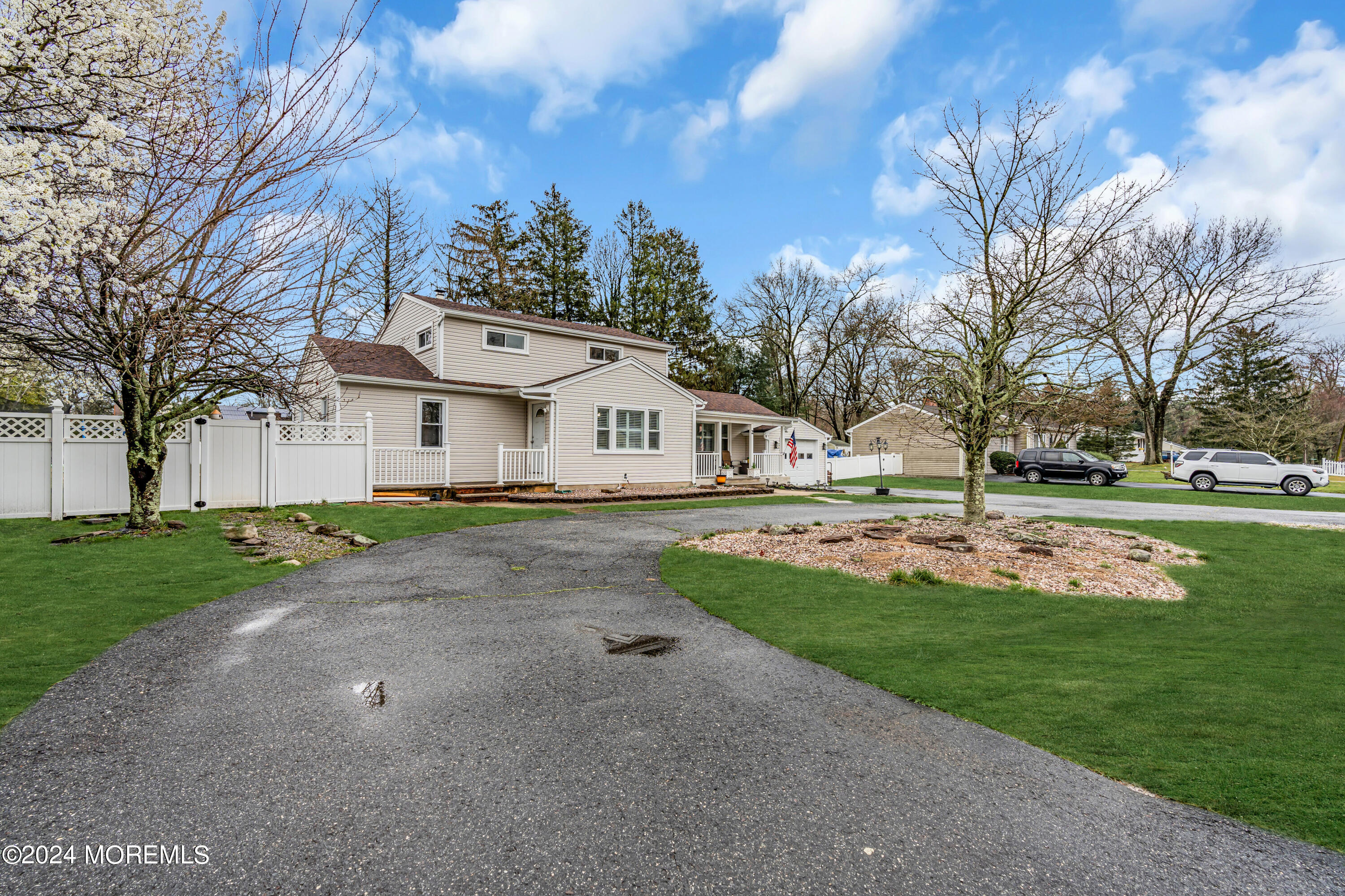 2 Maple Avenue Freehold, NJ 07728 - Photo 3 of 41 a view of a white house with a big yard and large trees