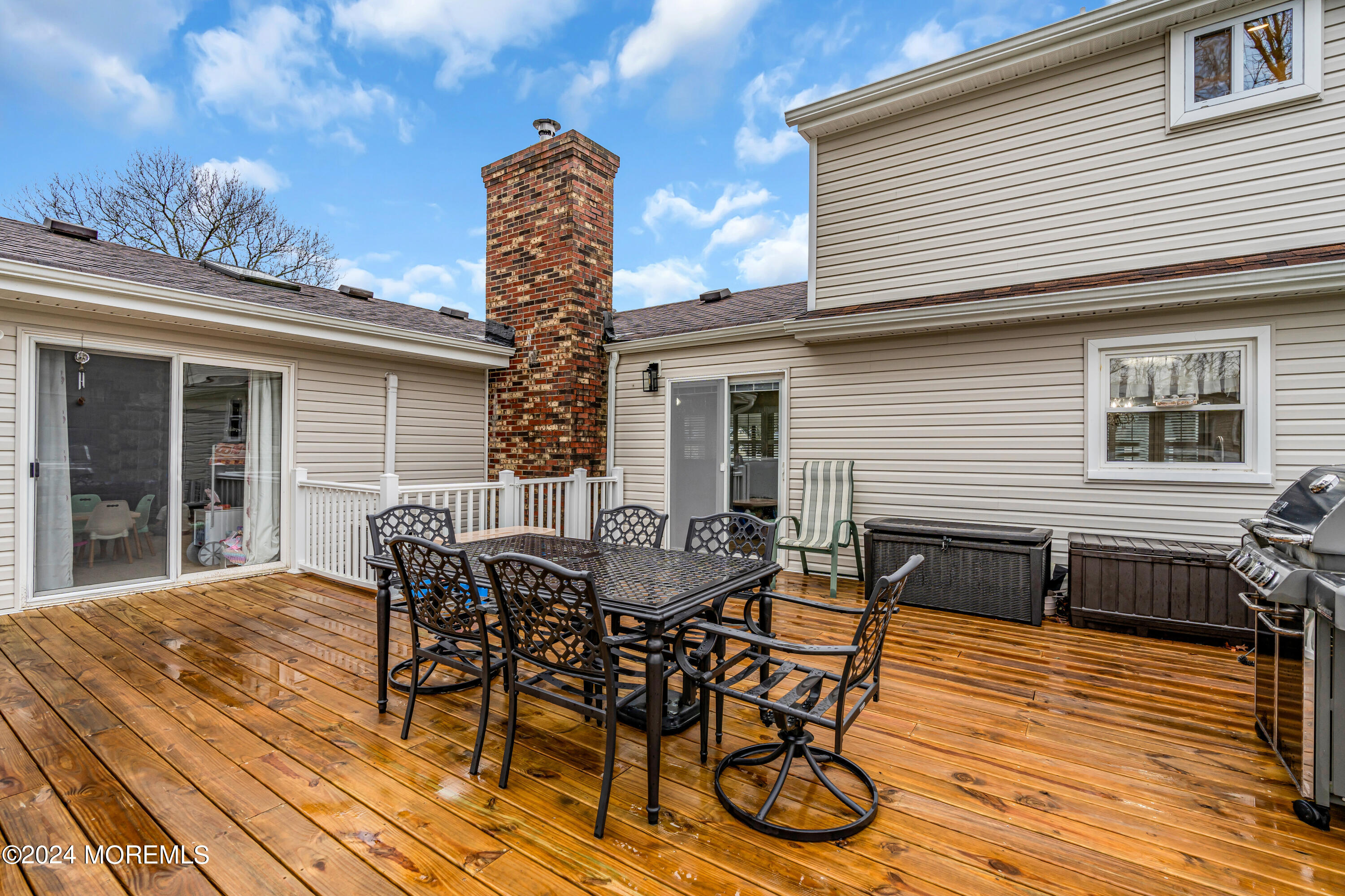 2 Maple Avenue Freehold, NJ 07728 - Photo 32 of 41 a view of a patio with table and chairs with wooden floor and fence