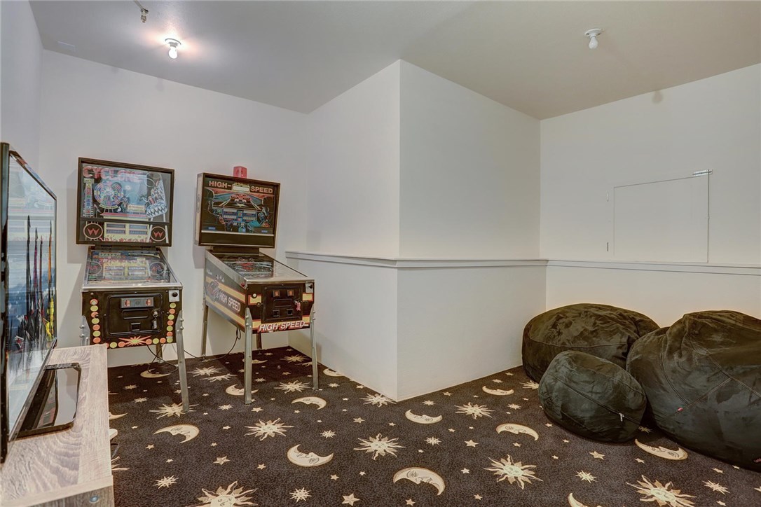 1381 Johnson Road Silverthorne, CO 80498 - Photo 28 of 35 Off the theater room is a secret game room with two pinball machines and a TV!