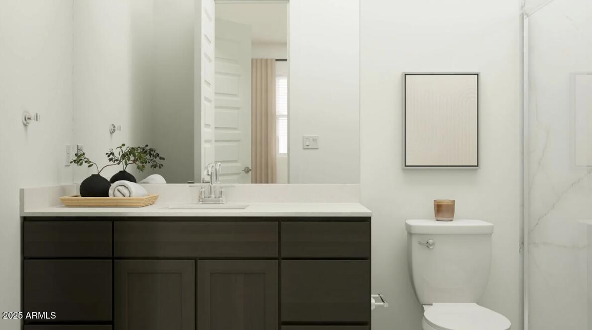 9646 West Flower Street Phoenix, AZ 85037 - Photo 13 of 25 a bathroom with a sink and a toilet