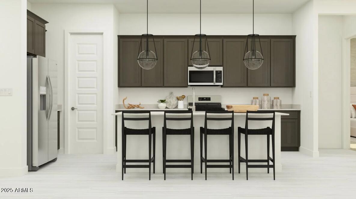 9646 West Flower Street Phoenix, AZ 85037 - Photo 2 of 25 a kitchen with a table chairs refrigerator and cabinets