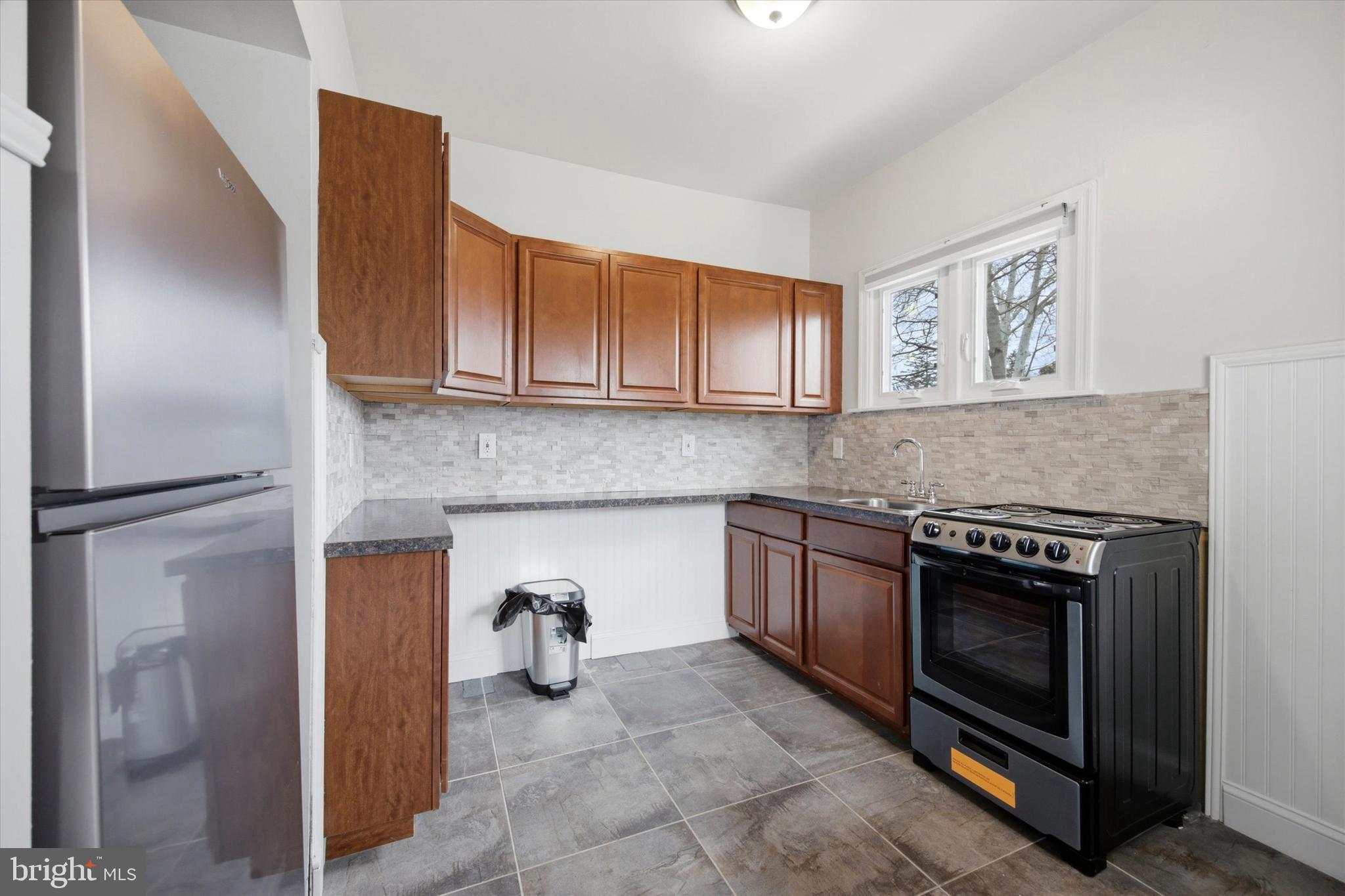 101 North Eagle Road, Unit 1 Havertown, PA 19083 - Photo 3 of 9 a kitchen with a stove and a refrigerator