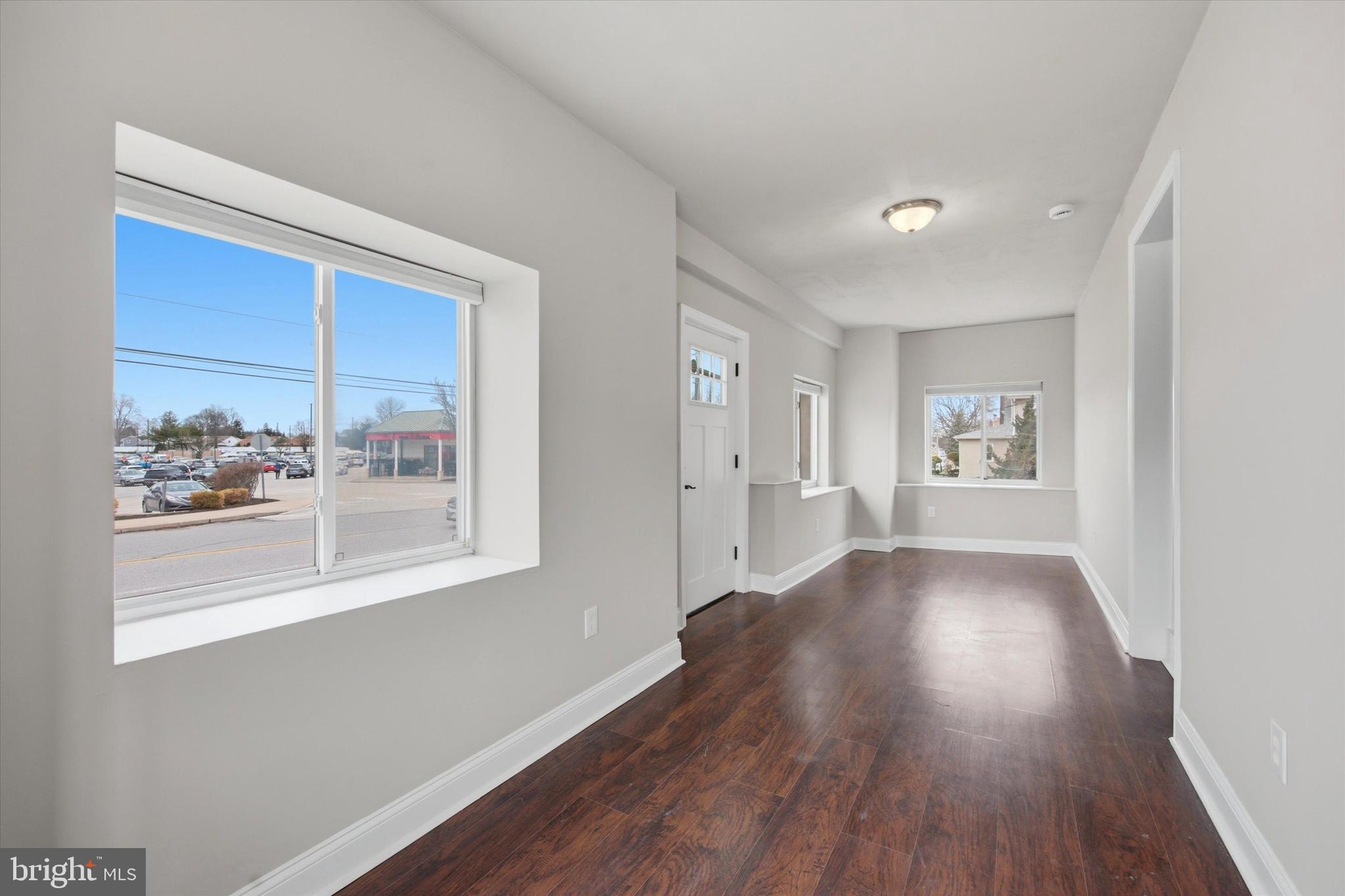 101 North Eagle Road, Unit 1 Havertown, PA 19083 - Photo 5 of 9 a view of an empty room with wooden floor and a window