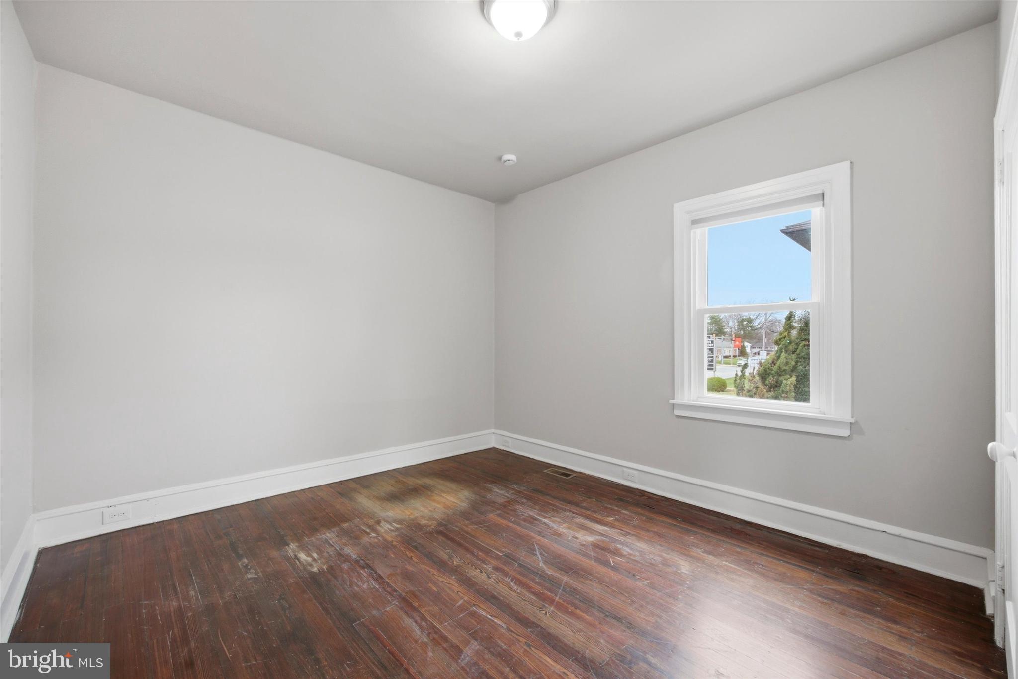 101 North Eagle Road, Unit 1 Havertown, PA 19083 - Photo 6 of 9 an empty room with wooden floor and windows