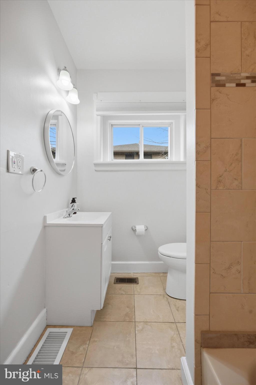 101 North Eagle Road, Unit 1 Havertown, PA 19083 - Photo 7 of 9 a bathroom with a toilet a sink a mirror and vanity