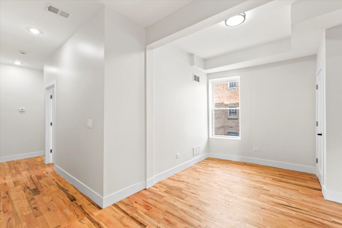 6128 South Rhodes Avenue, Unit 1 Chicago, IL 60637 - Photo 6 of 12 a view of empty room with wooden floor