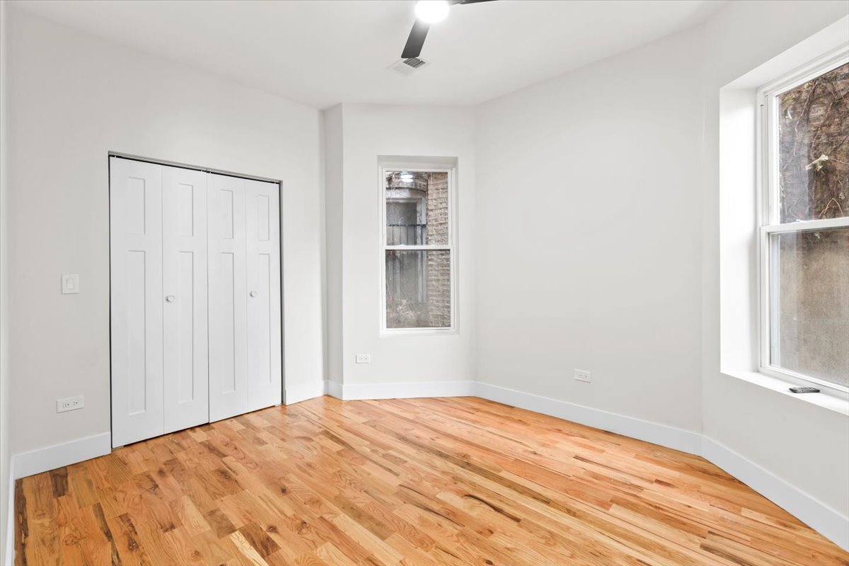 6128 South Rhodes Avenue, Unit 1 Chicago, IL 60637 - Photo 7 of 12 a bedroom with a bed and a window