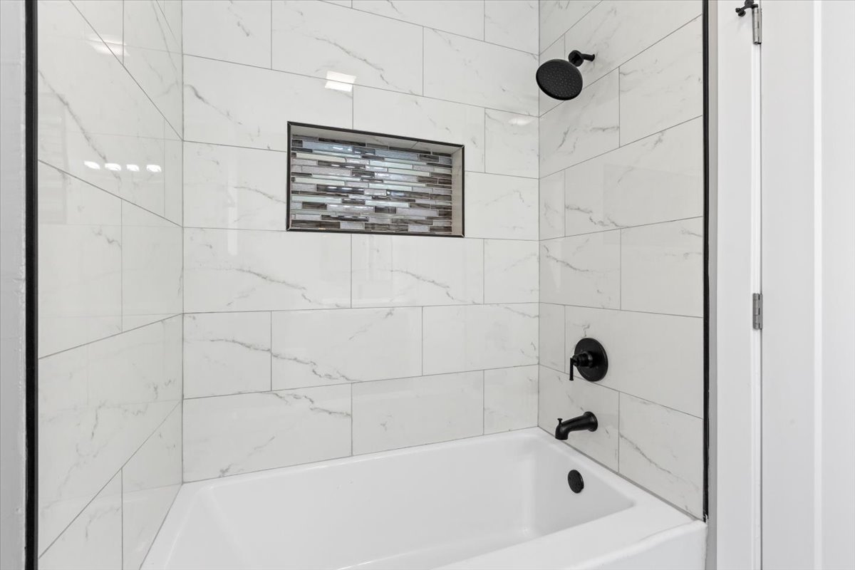 6128 South Rhodes Avenue, Unit 1 Chicago, IL 60637 - Photo 9 of 12 a bathroom with a bathtub and shower
