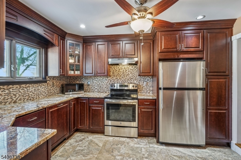 27 Espy Road, Unit A7 Caldwell, NJ 07006 - Photo 6 of 29 a kitchen with stainless steel appliances granite countertop a refrigerator and a sink