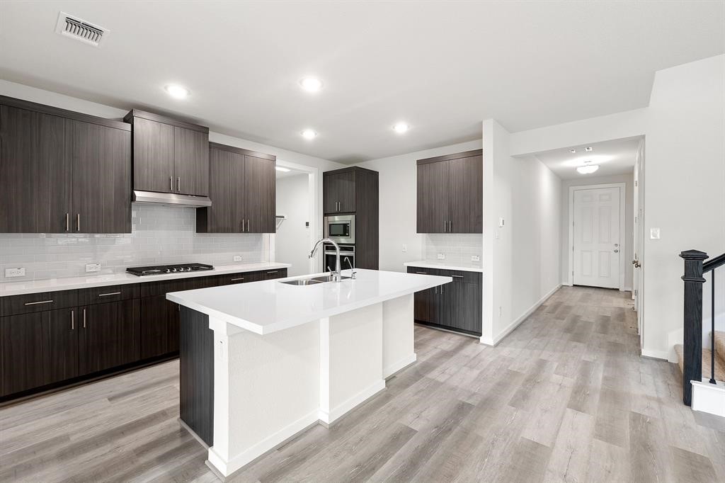 112 Alicante Lane Georgetown, TX 78628 - Photo 11 of 36 a kitchen with a sink stove and refrigerator