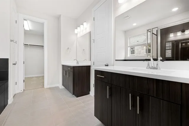 a bathroom with a double vanity sink mirror and double