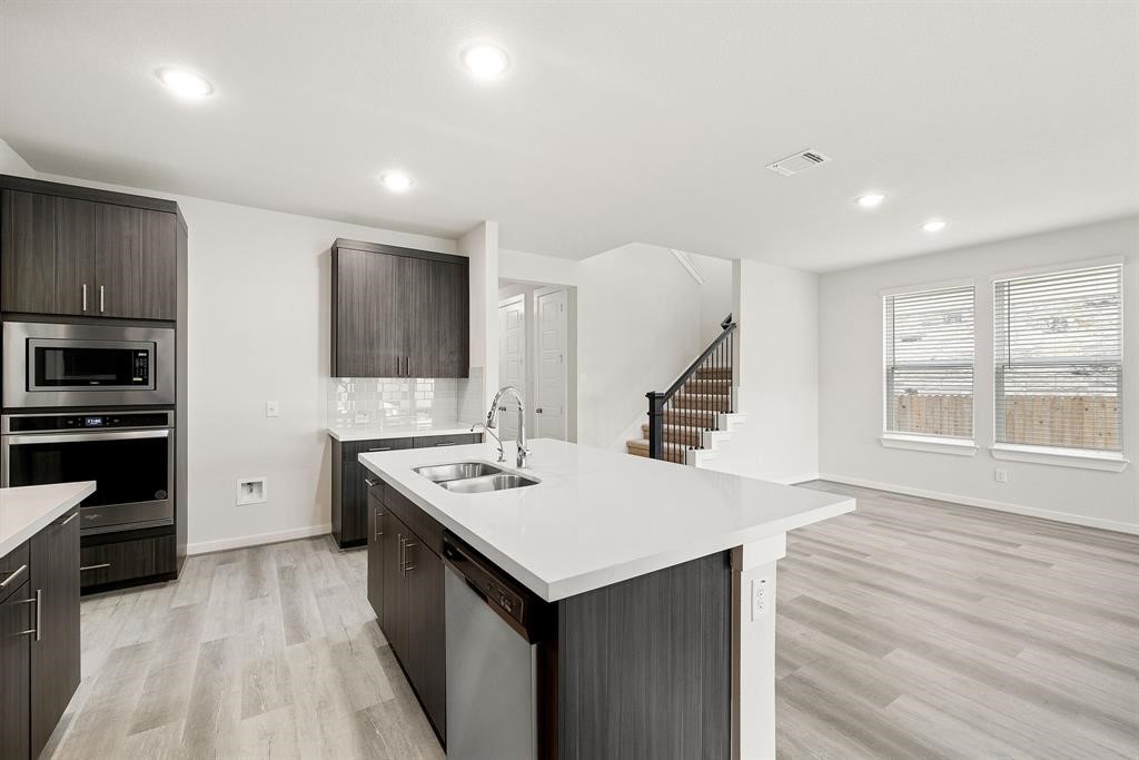 112 Alicante Lane Georgetown, TX 78628 - Photo 16 of 36 a kitchen with a stove a refrigerator and a sink