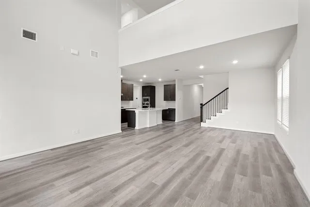 a view of a kitchen with wooden floor and a kitchen