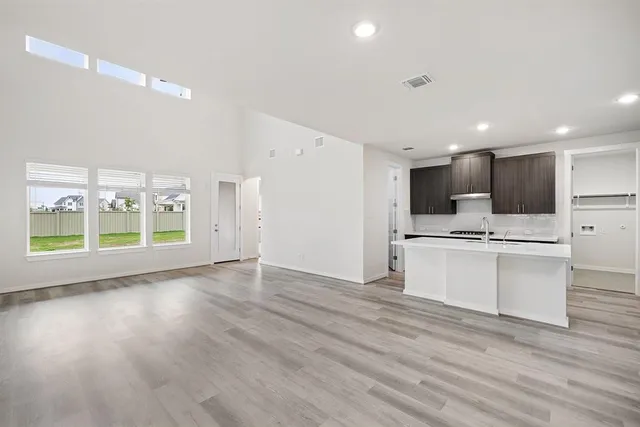 a view of kitchen with cabinets and wooden floor