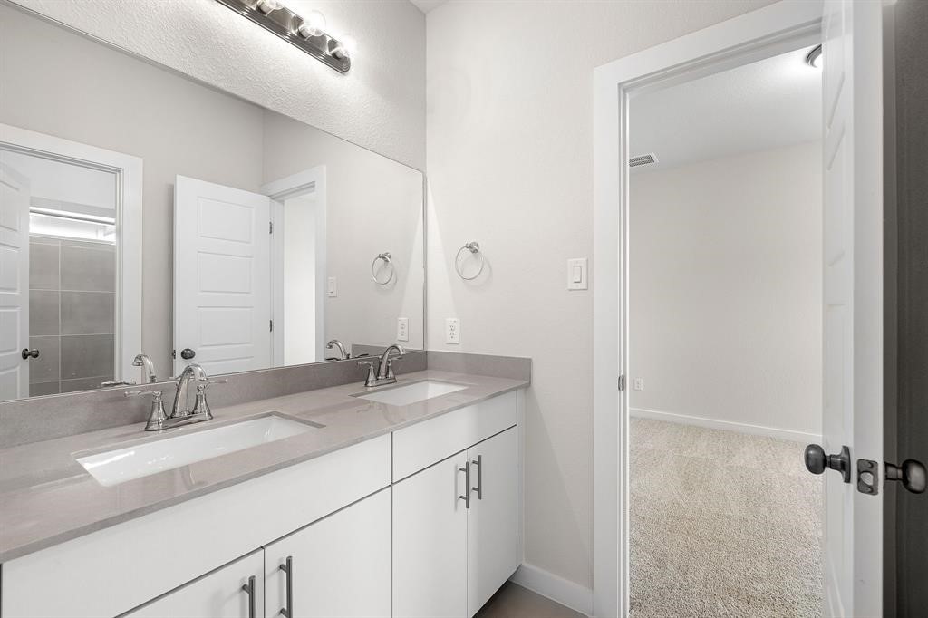 112 Alicante Lane Georgetown, TX 78628 - Photo 21 of 36 a bathroom with a granite countertop sink and a mirror