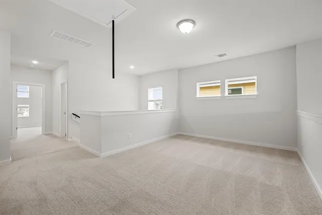 an empty room with windows and entrance