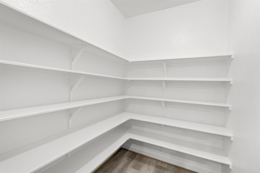 112 Alicante Lane Georgetown, TX 78628 - Photo 27 of 36 a view of walk in closet with empty racks