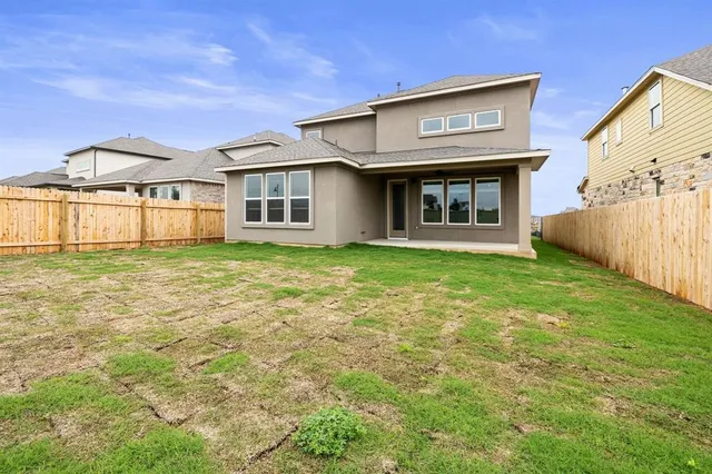 a view of a house with a yard and sitting area