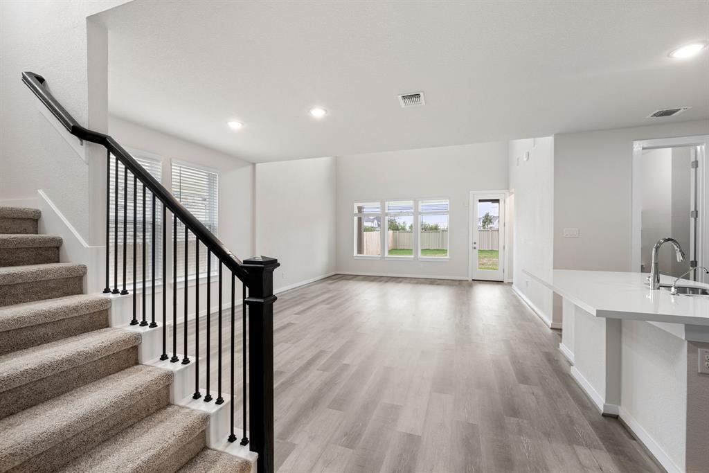 112 Alicante Lane Georgetown, TX 78628 - Photo 4 of 36 a view of a hallway with wooden floor and staircase