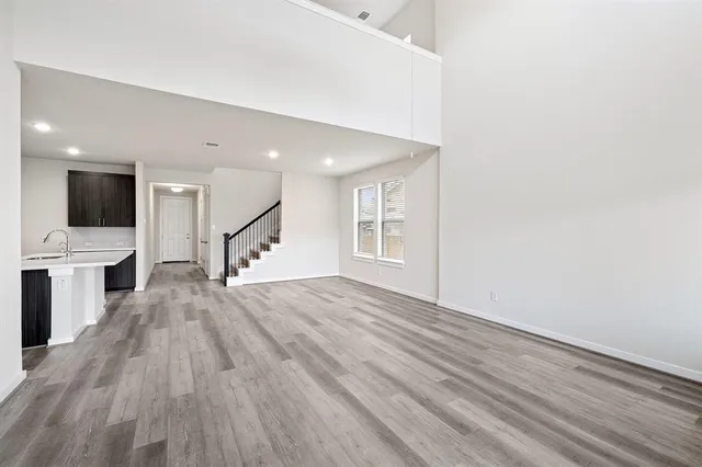 a view of a kitchen with wooden floor and electronic appliances