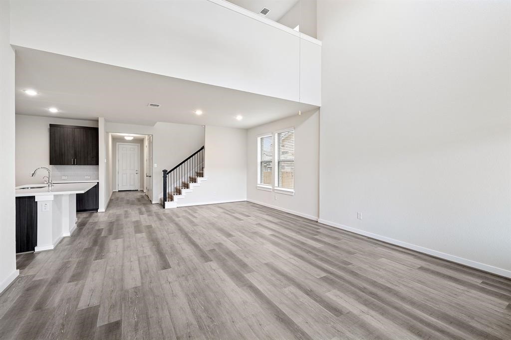 112 Alicante Lane Georgetown, TX 78628 - Photo 5 of 36 a view of a kitchen with wooden floor and electronic appliances