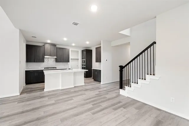 a view of kitchen with cabinets and wooden floor