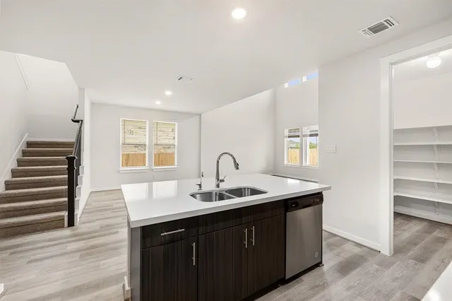 a kitchen with a sink and cabinets