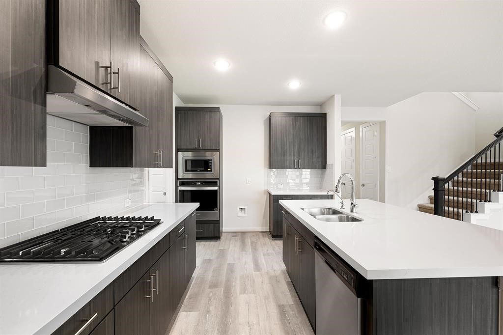 112 Alicante Lane Georgetown, TX 78628 - Photo 10 of 36 a kitchen with a sink a stove and cabinets