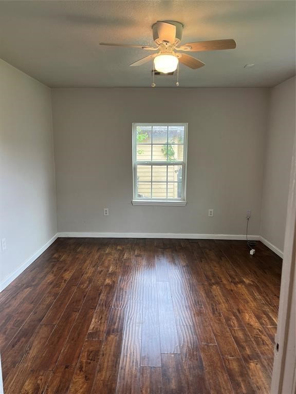 7227 St Augustine Street Houston, TX 77021 - Photo 14 of 20 wooden floor in an empty room with a window