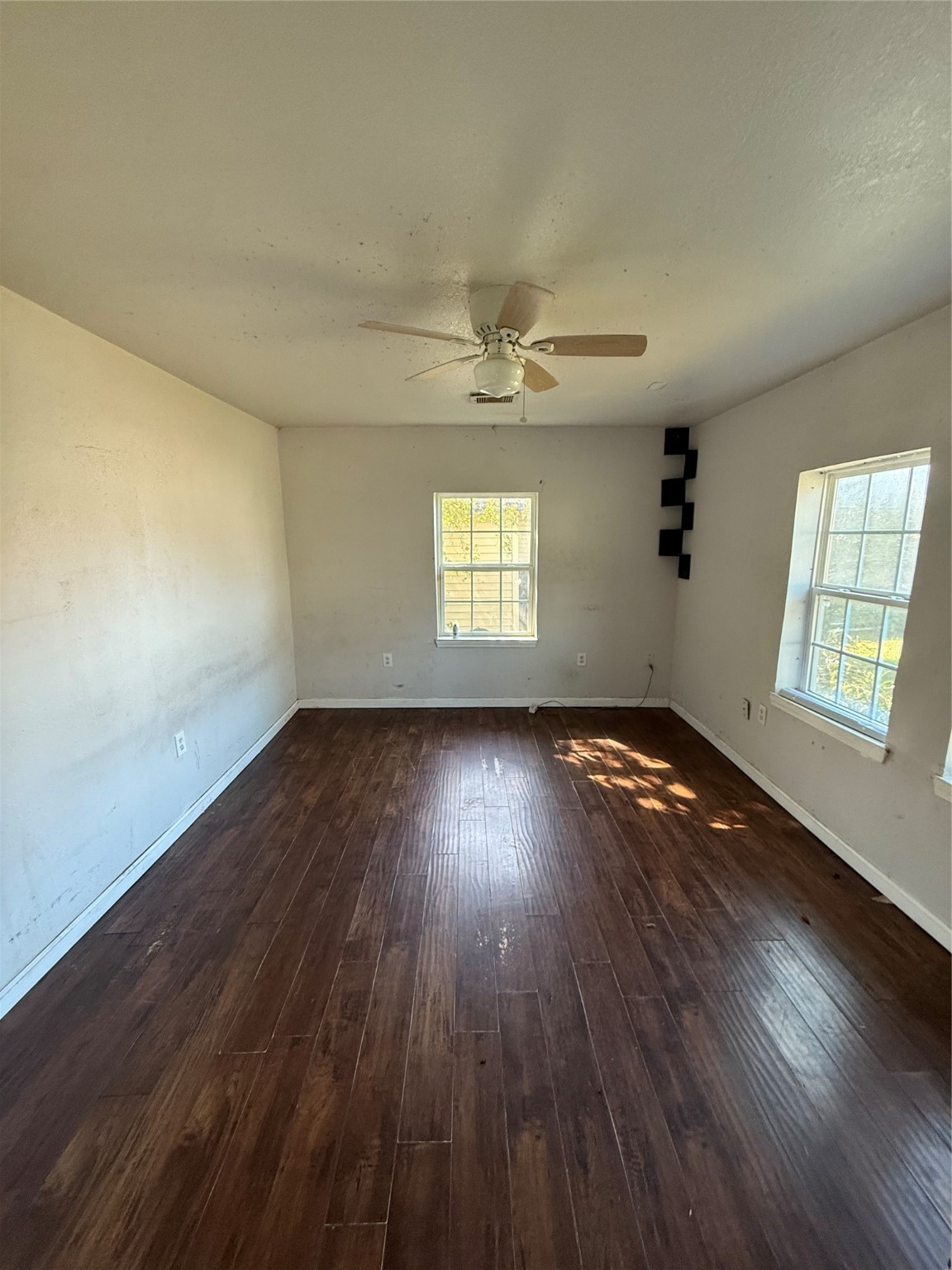 7227 St Augustine Street Houston, TX 77021 - Photo 16 of 20 an empty room with wooden floor and windows