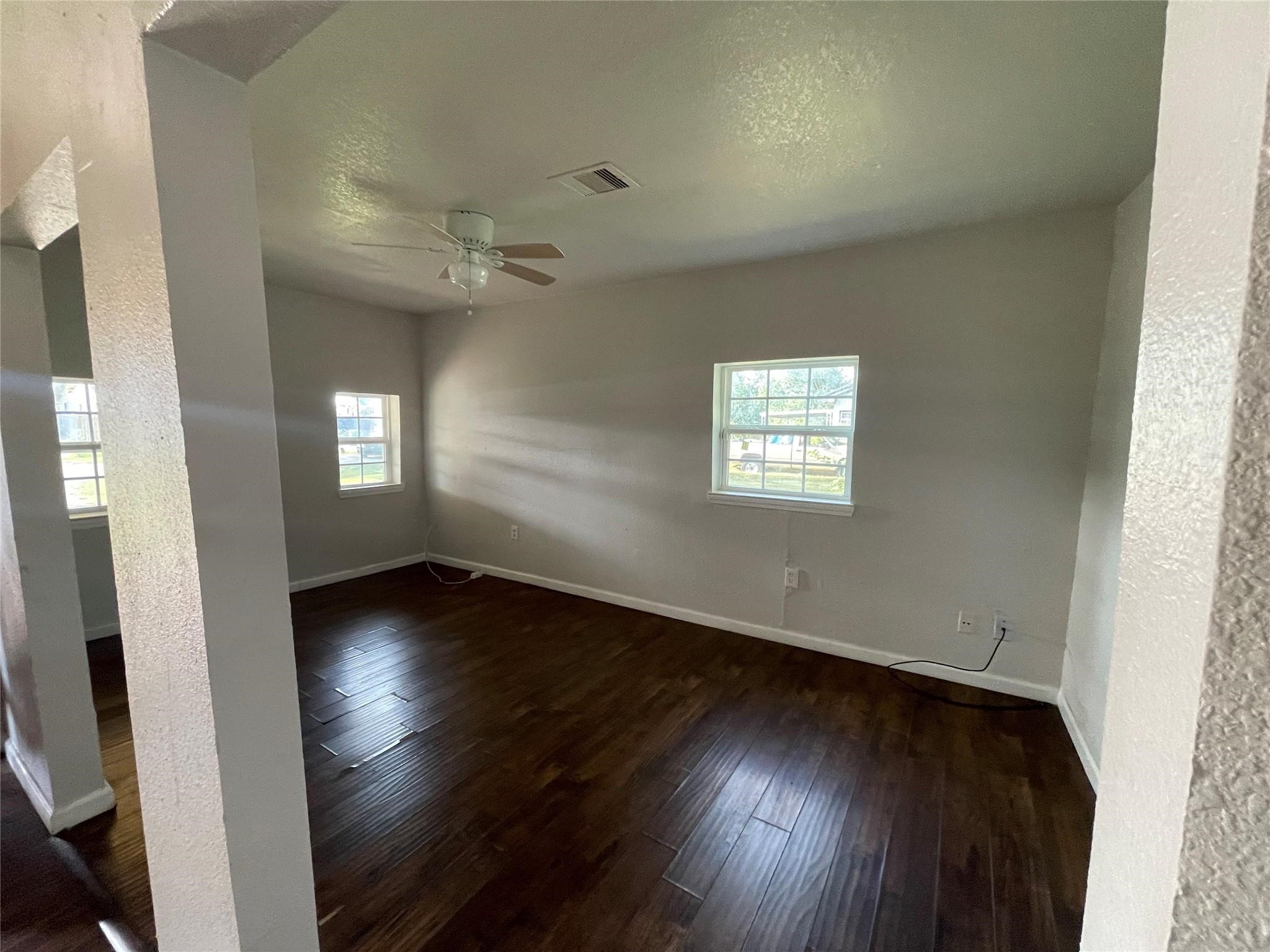 7227 St Augustine Street Houston, TX 77021 - Photo 6 of 20 an empty room with wooden floor and windows