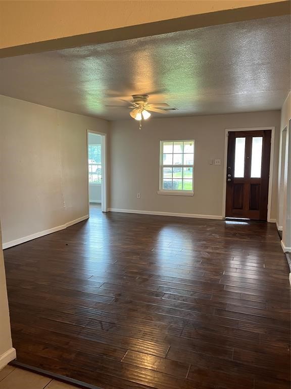 7227 St Augustine Street Houston, TX 77021 - Photo 7 of 20 an empty room with wooden floor and windows
