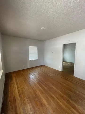 a view of an empty room and wooden floor