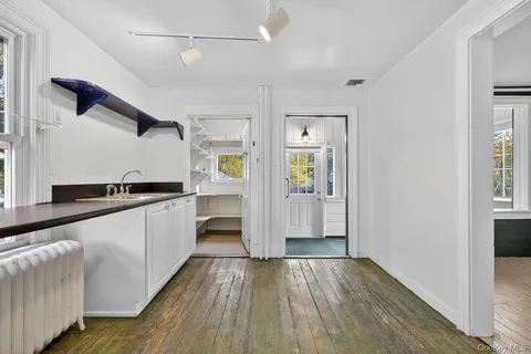 a large kitchen with cabinets and wooden floor