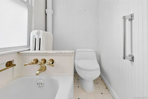 a bathroom with a toilet and a sink