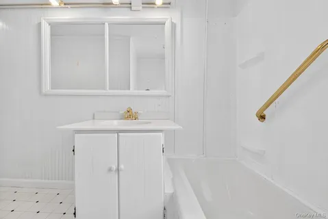 a bathroom with a sink vanity and a mirror