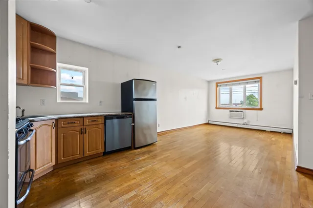 a kitchen with granite countertop a refrigerator and a stove