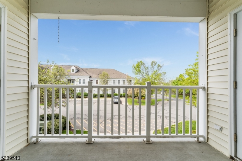 6015 Brookfield Glen Drive, Unit 15 Belvidere, NJ 07823 - Photo 20 of 48 a view of a porch with a floor to ceiling window and stairs