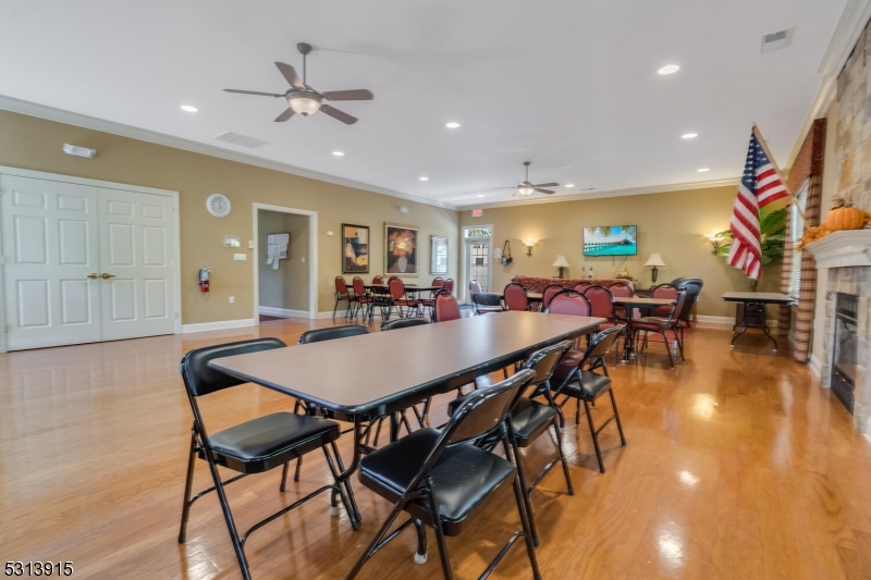 6015 Brookfield Glen Drive, Unit 15 Belvidere, NJ 07823 - Photo 28 of 48 a dining hall with stainless steel appliances a dining table and chairs with wooden floor