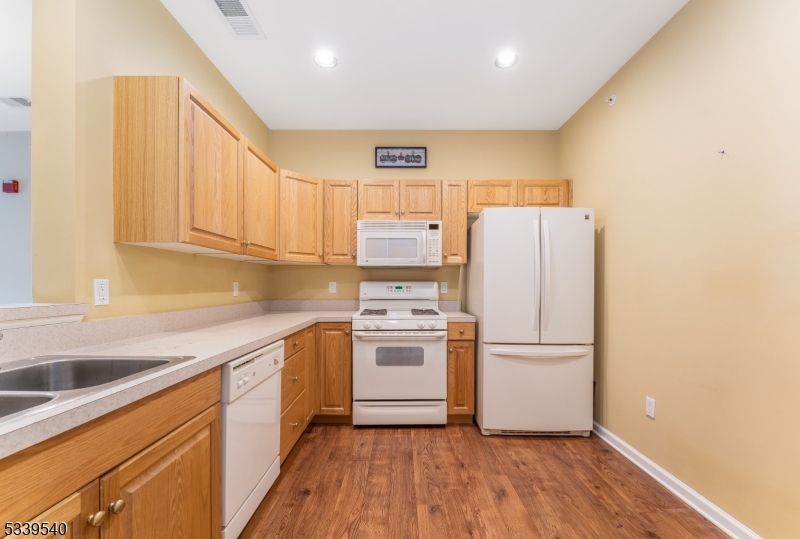 6015 Brookfield Glen Drive, Unit 15 Belvidere, NJ 07823 - Photo 3 of 48 a kitchen with a refrigerator sink and cabinets
