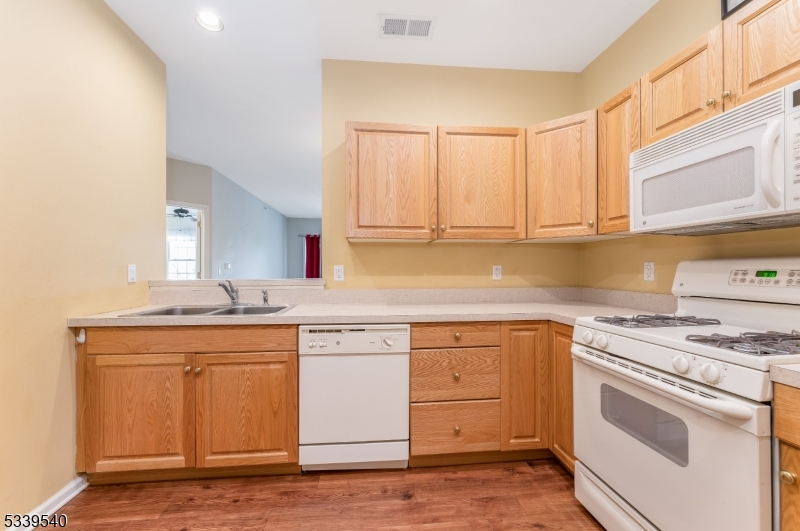 6015 Brookfield Glen Drive, Unit 15 Belvidere, NJ 07823 - Photo 4 of 48 a kitchen with a sink stove and cabinets