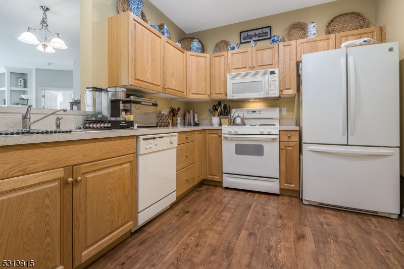 6015 Brookfield Glen Drive, Unit 15 Belvidere, NJ 07823 - Photo 5 of 48 a kitchen with a white cabinets and white appliances