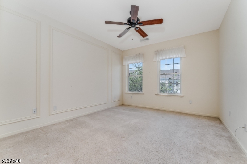 6015 Brookfield Glen Drive, Unit 15 Belvidere, NJ 07823 - Photo 7 of 48 an empty room with ceiling fan and windows
