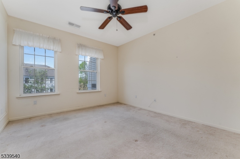 6015 Brookfield Glen Drive, Unit 15 Belvidere, NJ 07823 - Photo 8 of 48 an empty room with windows and fan
