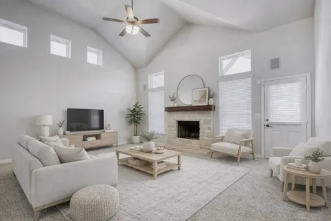 a living room with furniture a fireplace and a flat screen tv